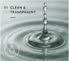A clear water drop creating ripples in a quiet surface