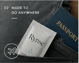Rynse packet beside a passport in a travel bag